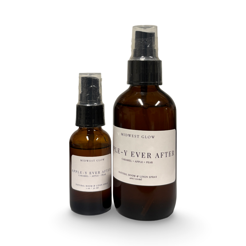 Two amber glass bottles with black spray nozzles and white labels on a white background