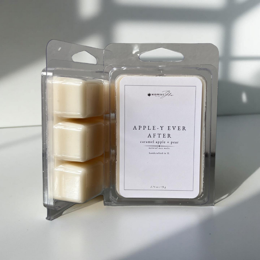 Appley Ever After Wax Melts by Midwest Glow sit against a white backdrop with subtle studio lighting to create a product highlight for the Signature Collection