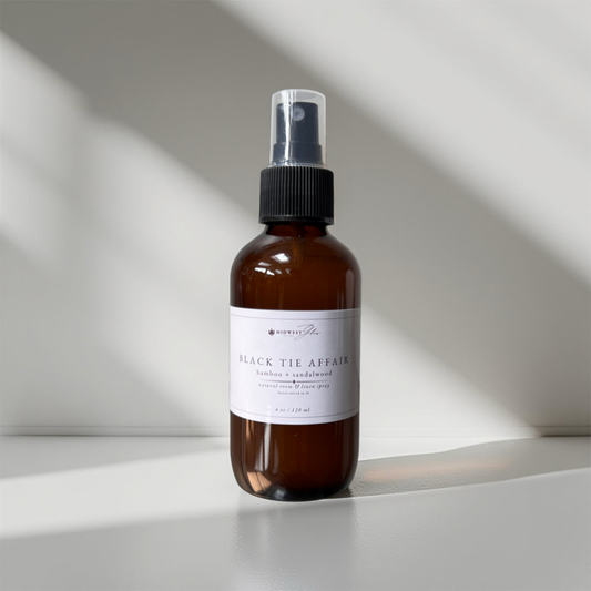 Black Tie Affair Room Spray by Midwest Glow sits against a white backdrop with subtle shadows showcasing the product as part of the new Signature Collection
