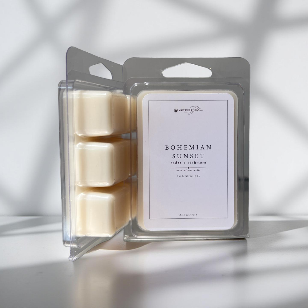 Packaged candle melts with 'Bohemian Sunset' label on a neutral background