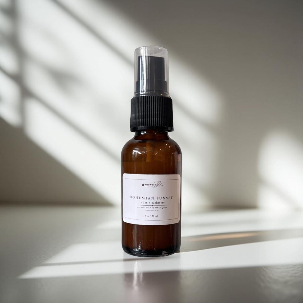 Bohemian sunset spray by Midwest Glow sits against a white photo backdrop with subtle shadows highlighting the product