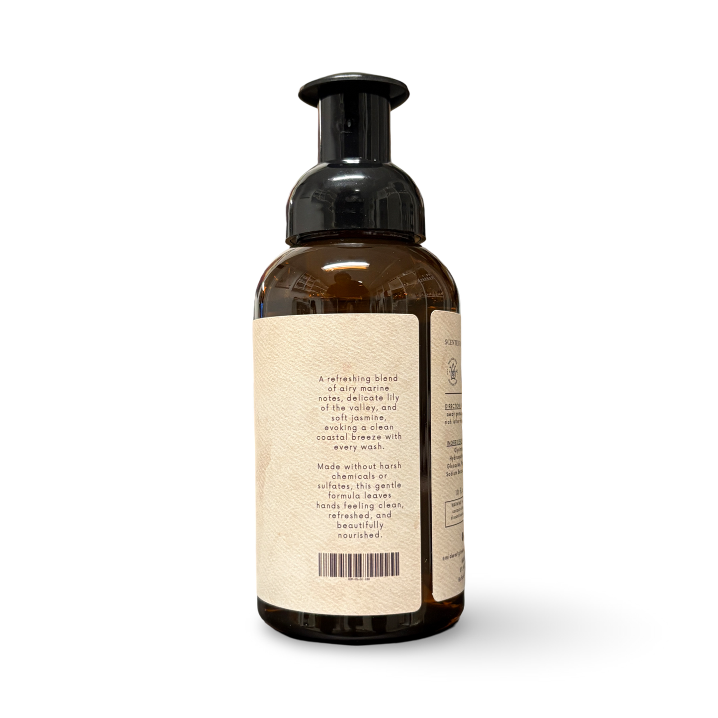Brown bottle with pump and beige label on a white background