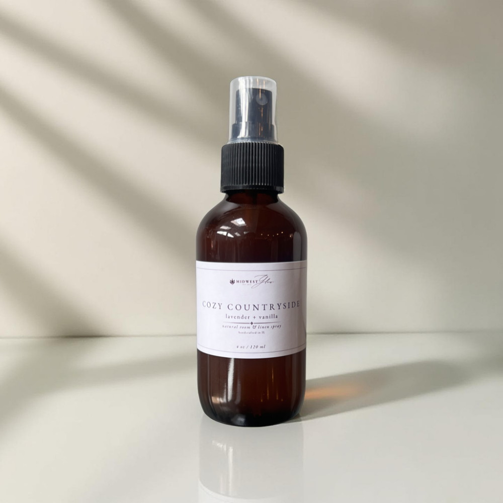 Cozy Countryside room spray by Midwest Glow sits against a white background with subtle shadows to highlight the product details.