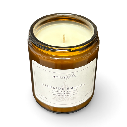 Candle in a glass jar with a label on a white background