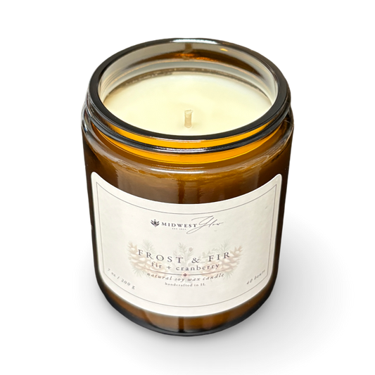 Candle in a glass jar with a label on a white background