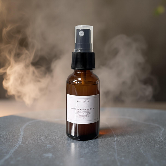 Brown spray bottle with a label on a gray surface with smoke in the background