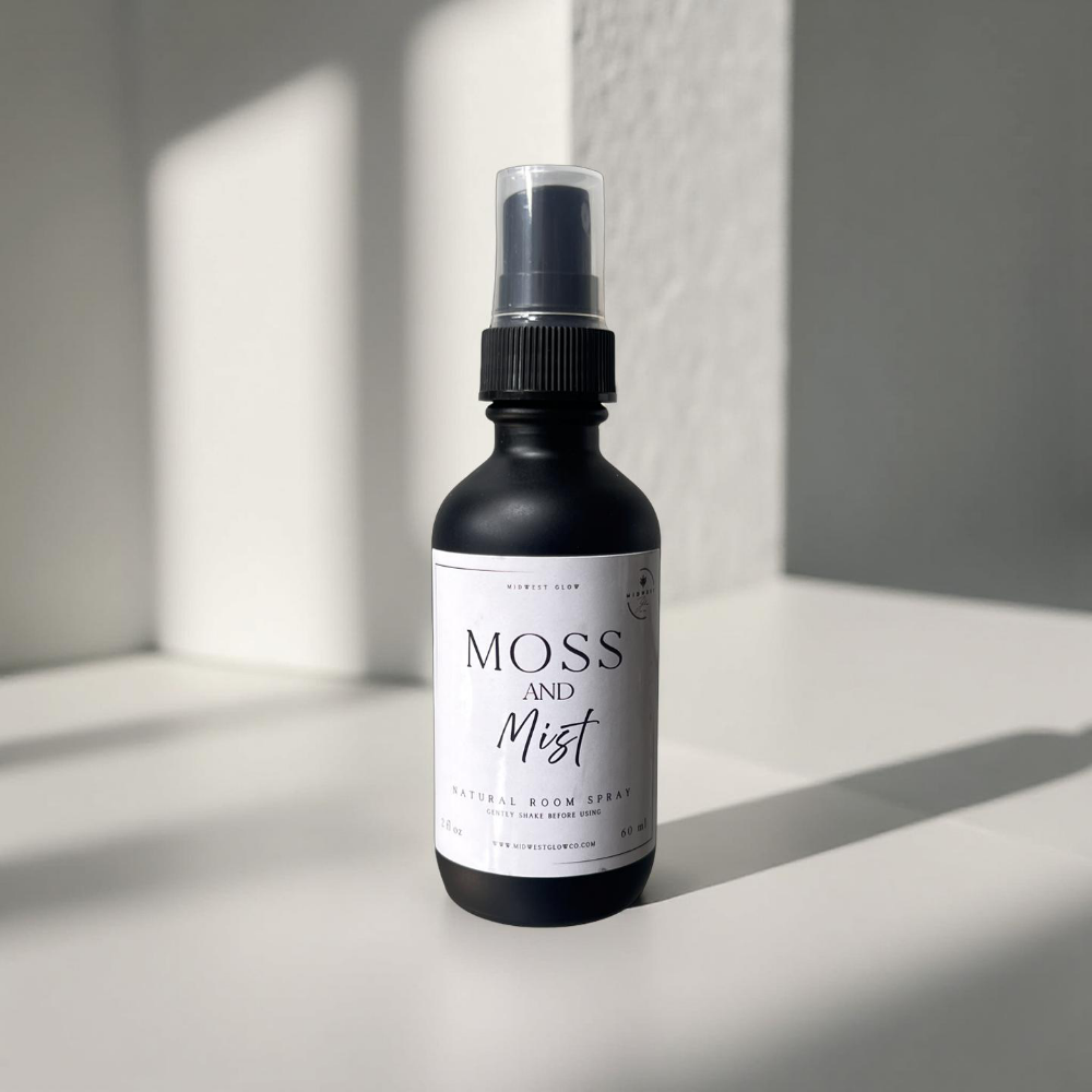 Moss And Mist Room Spray by Midwest Glow sits against a white backdrop with subtle shadows showcasing the product