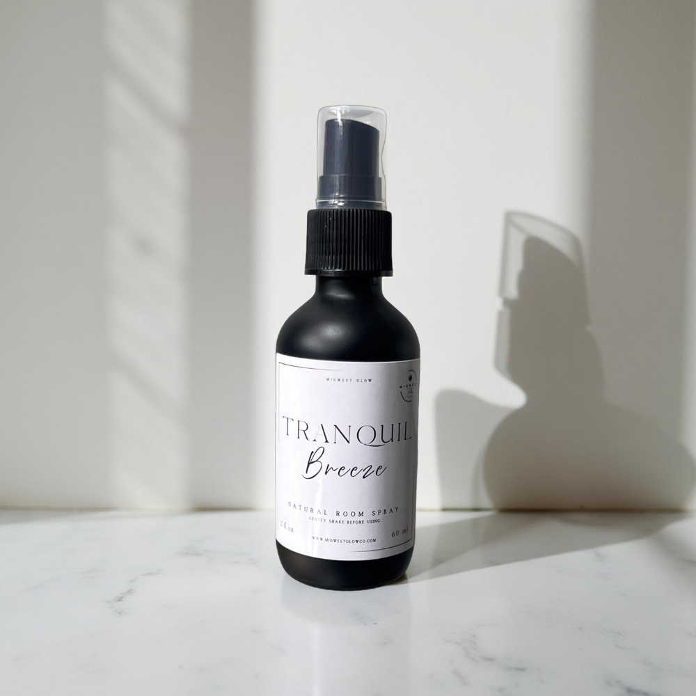 Tranquil Breeze Room Spray by Midwest Glow sits in front of a white backdrop with subtle shadows and natural lighting to create a product highlight