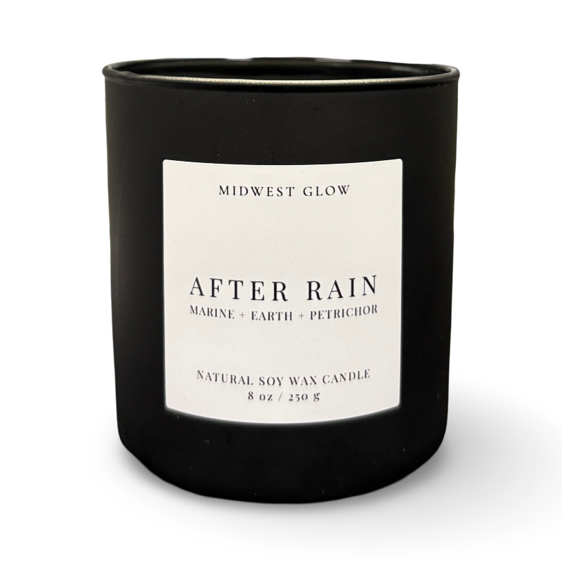 Black candle with a white label on a white background