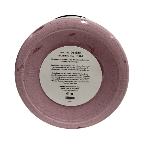 A round jar of Enchanted Roots Amber Orchid Enmulsifying Body Polish, showing the back of the container with a white label and a hint of the black lid at the top, on a white background.