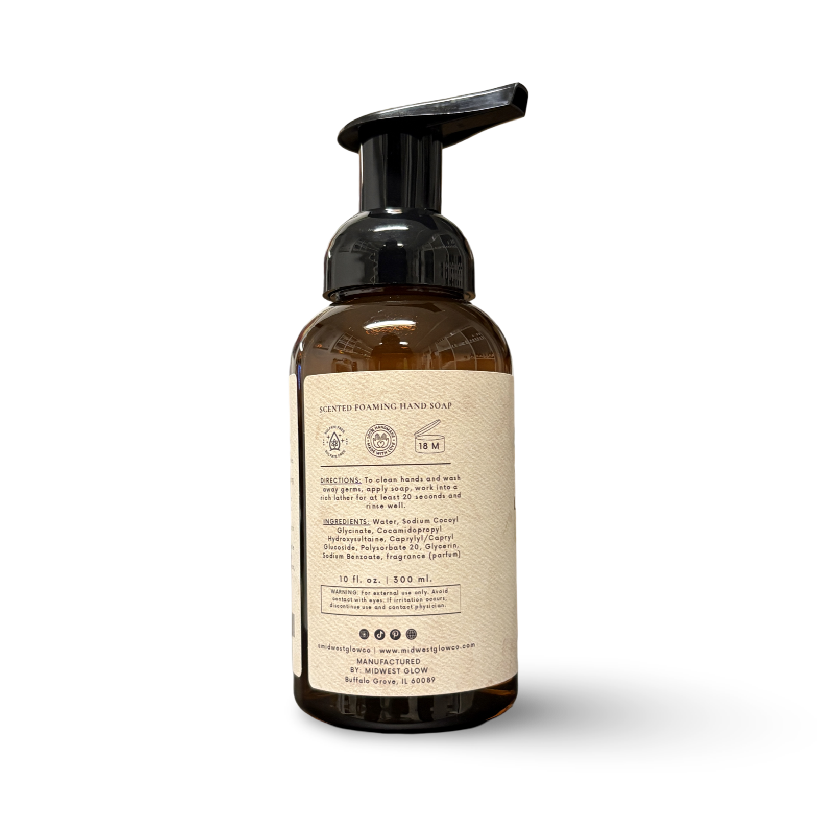 Brown foaming hand soap bottle with label on a white background