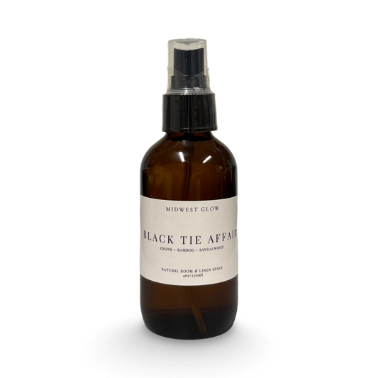 Brown spray bottle labeled 'Black Tie Affair' on a white background