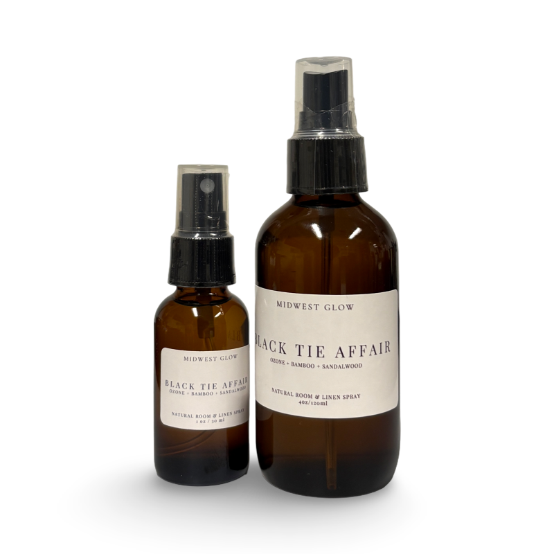 Two brown spray bottles labeled 'Black Tie Affair' on a white background