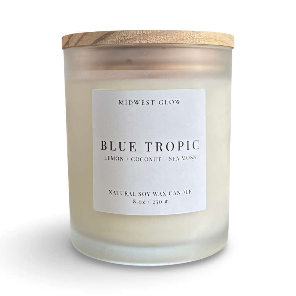 Candle with a wooden lid labeled 'Blue Tropic' by Midwest Glow on a white background