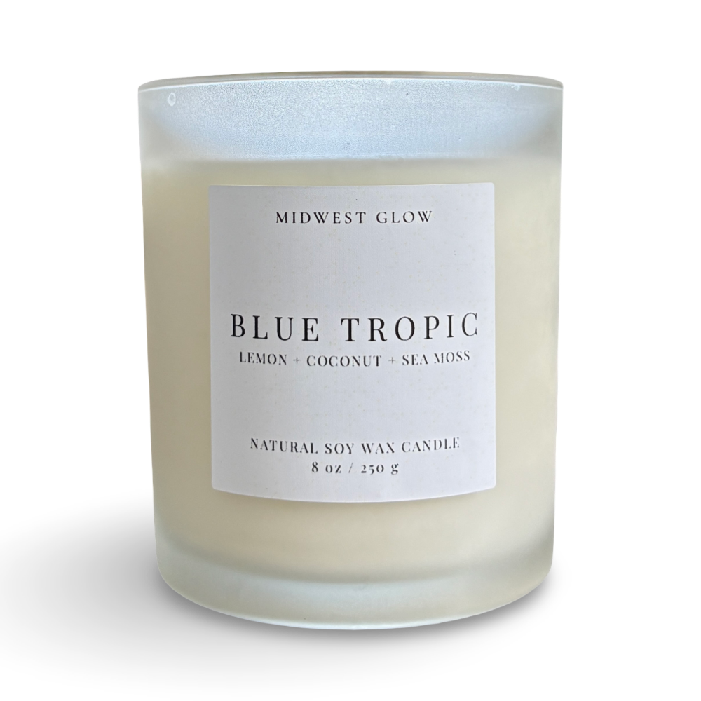 Candle with a label reading 'Blue Tropic' by Midwest Glow on a white background