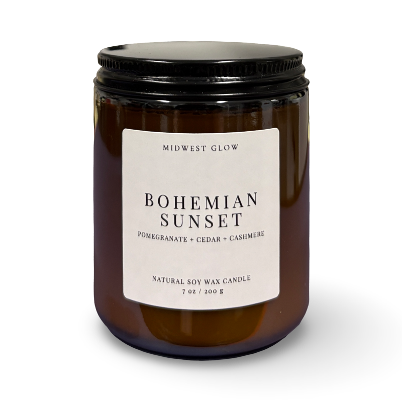 Candle with a label reading 'Bohemian Sunset' on a white background