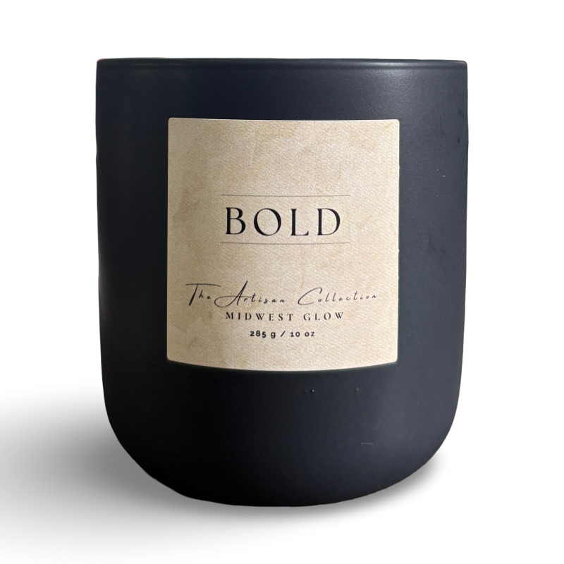 Black candle with a beige label on a white background
