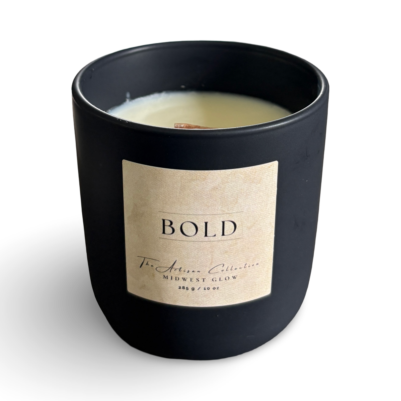 Black candle with a beige label on a white background