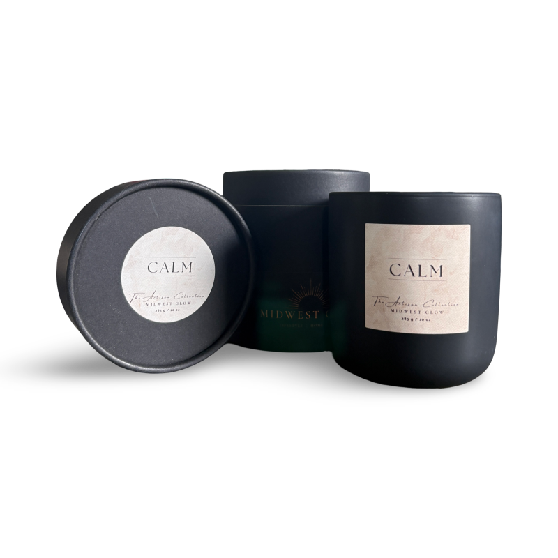 Black candle with 'Calm' label and packaging on a white background