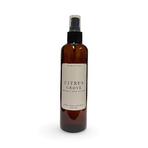 An amber glass spray bottle with a black spray top and a cream-colored label reading 'Citrus Grove' by 'Mushroom Glow', set against a plain white background.