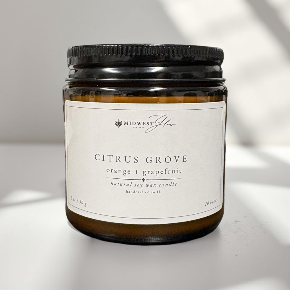 Candle jar labeled 'Citrus Grove' by Midwest Glow on a light background