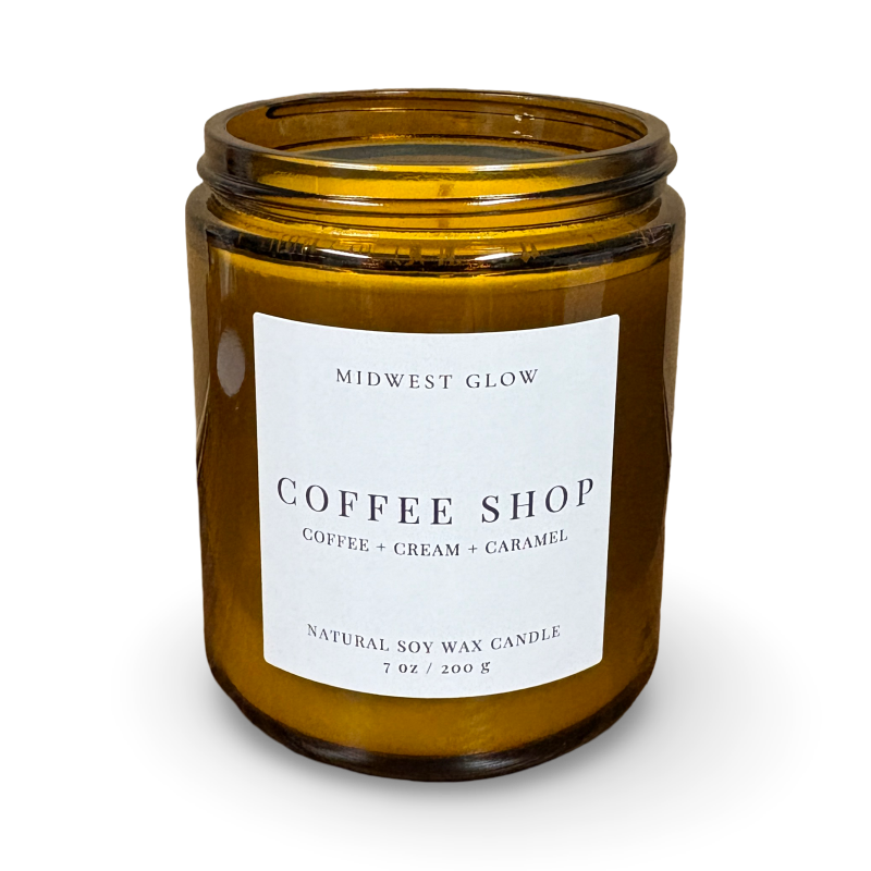Amber glass candle with a label on a white background