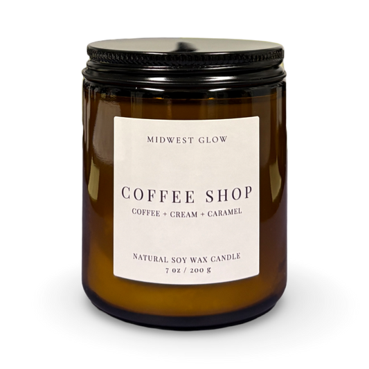 Amber glass candle with a label on a white background
