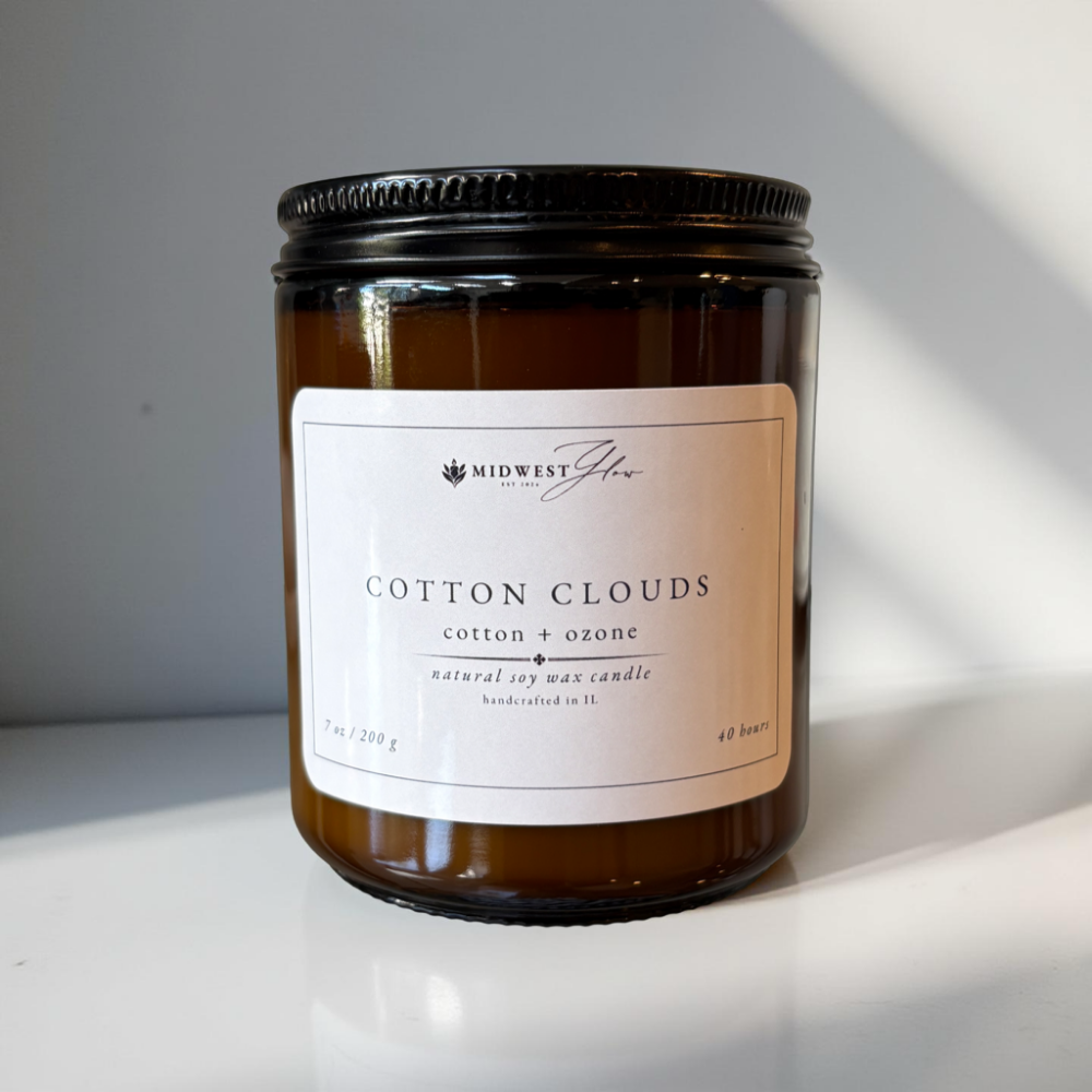 Candle with a label on a reflective surface