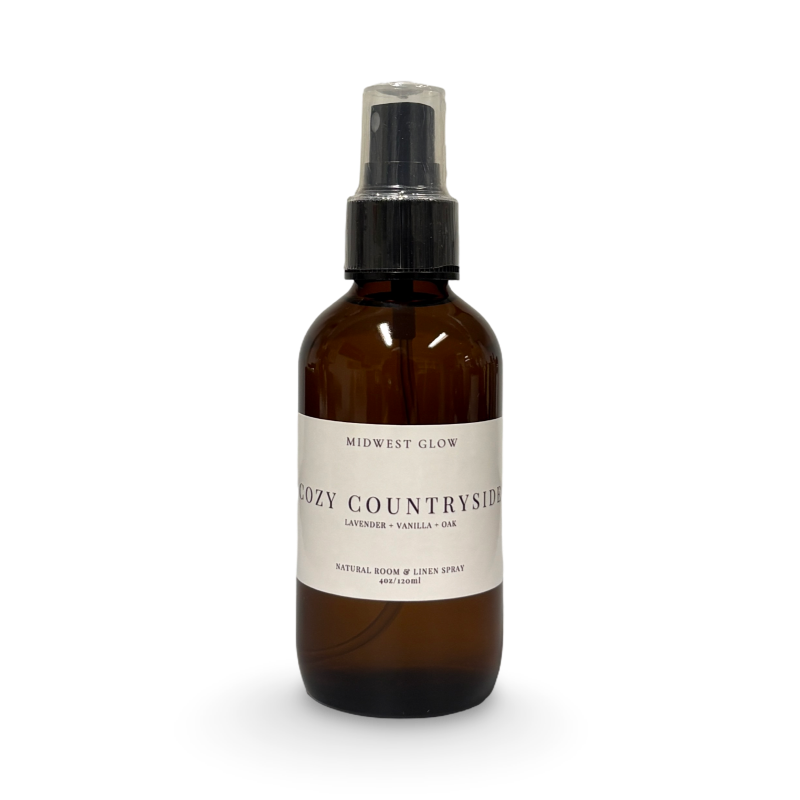 Brown spray bottle labeled 'Cozy Countryside' on a white background
