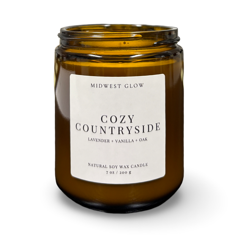 Amber glass candle with a label on a white background