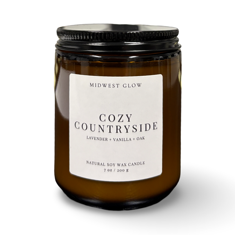 Candle jar labeled 'Cozy Countryside' by Midwest Glow on a white background