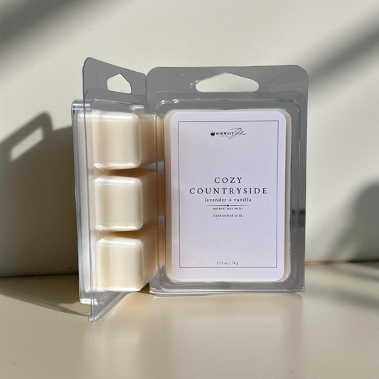 Packaged wax melts labeled 'Cozy Countryside' on a neutral background