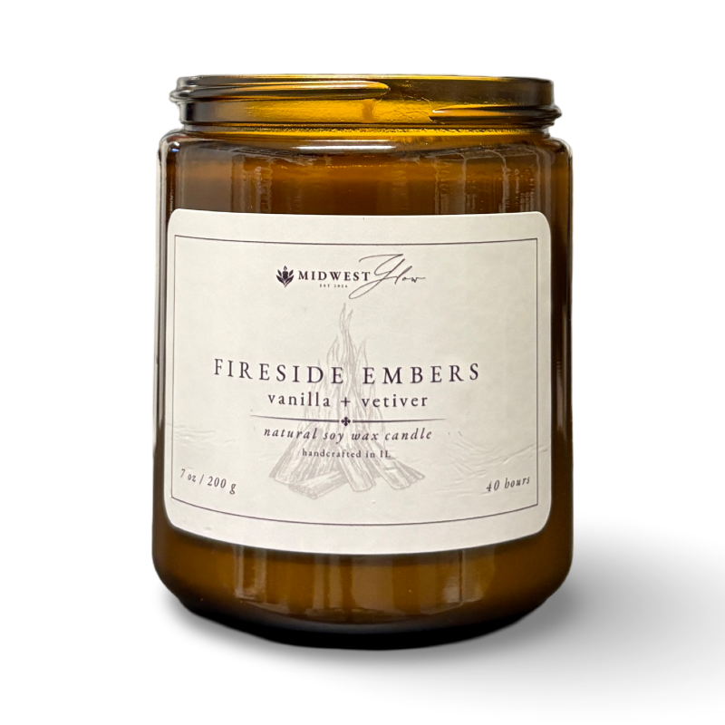 Amber glass candle with a label on a white background