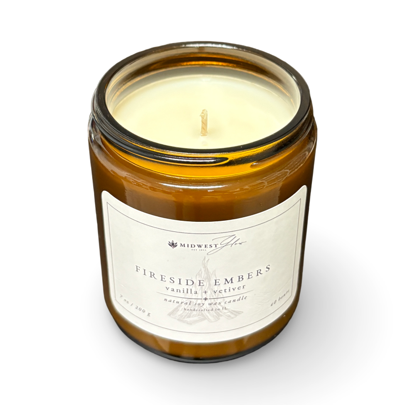Candle in a glass jar with a label on a white background