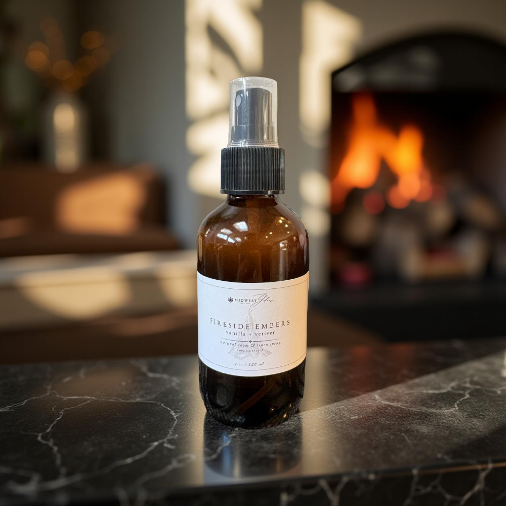 Brown glass bottle with a label on a dark surface with a fireplace in the background