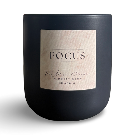 Black candle with a 'Focus' label on a white background