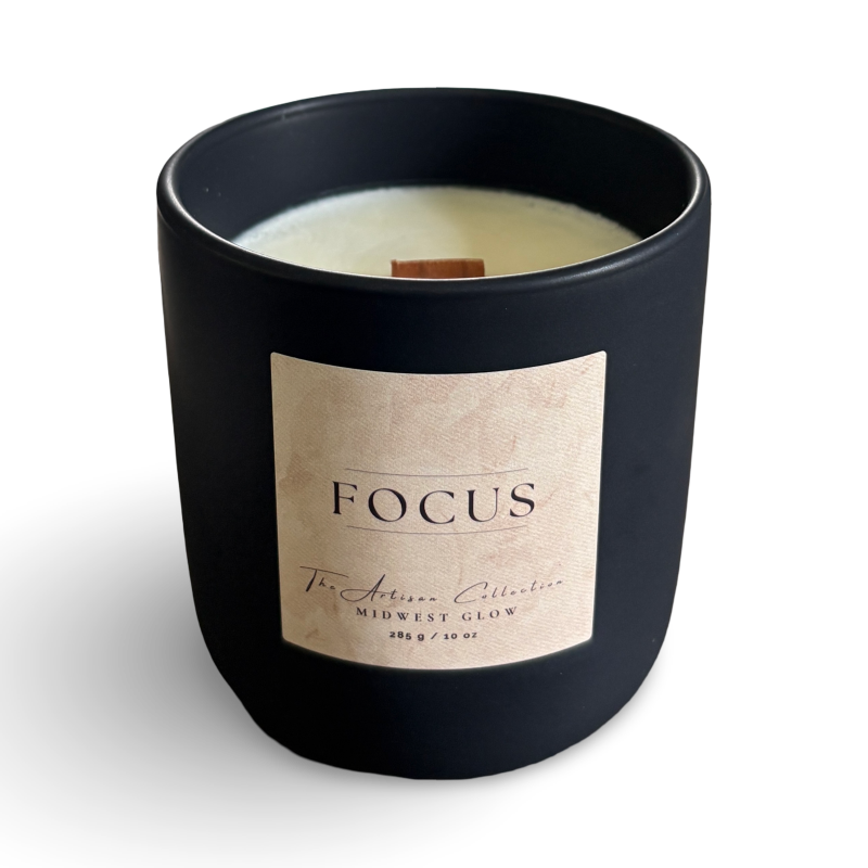 Black candle with a beige label on a white background