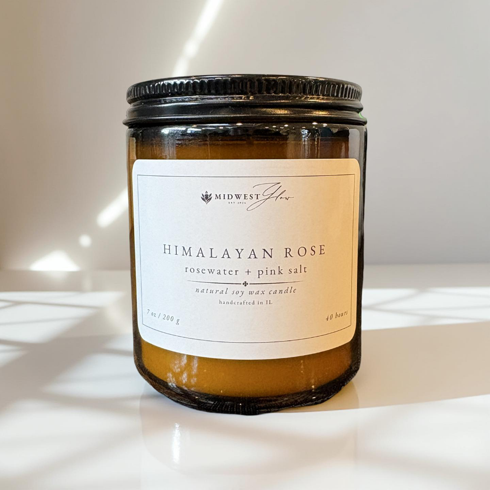 Himalayan Rose candle with a label on a white surface