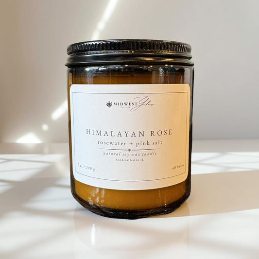 Himalayan Rose candle with a label on a white surface