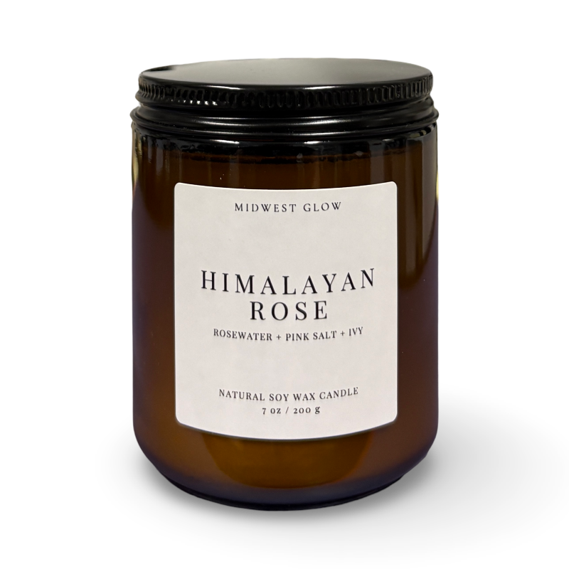 Himalayan Rose candle with a black lid and label on a white background