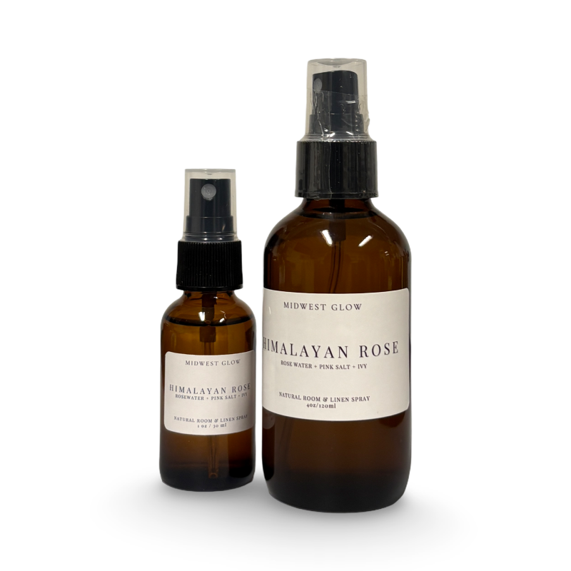 Two brown glass bottles with black sprayers and white labels on a white background