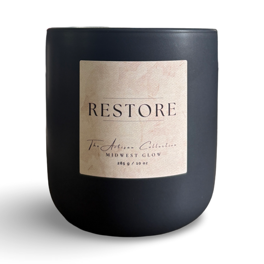 Black candle with a 'Restore' label on a white background