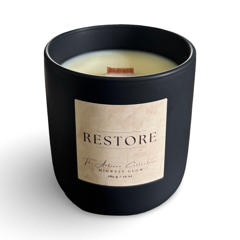 Black candle with 'RESTORE' label on a white background