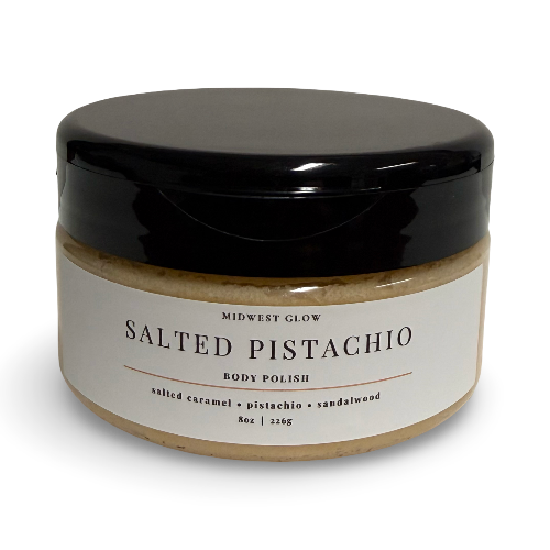 A jar of Midwest Glow Salted Pistachio Body Polish with a black lid and a white label, set against a plain white background.