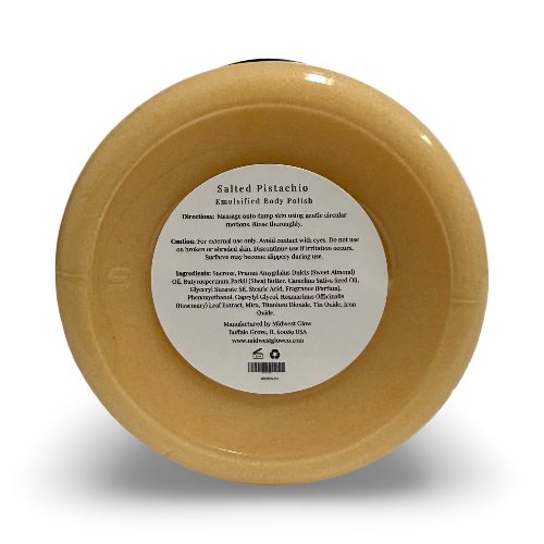 A round beige body polish jar with a white label reading 'Salted Pistachio Enriched Body Polish' on a white background.