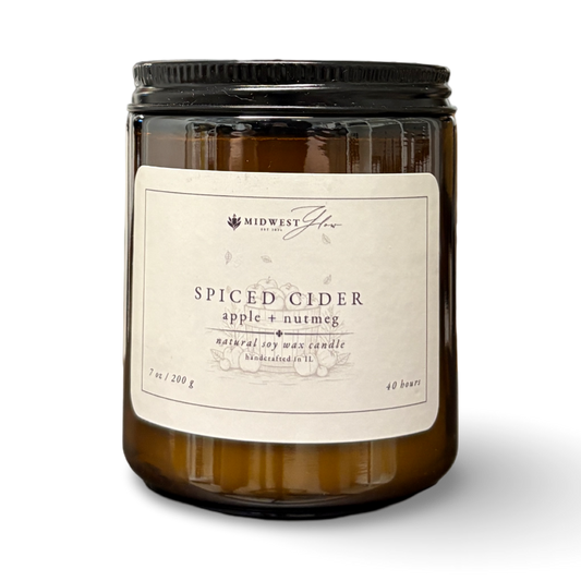 Candle with a Spiced Cider label on a white background