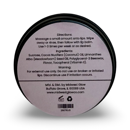 The back of a round black plastic container of lip balm, showing printed directions, ingredients, and contact information on a light lavender background.