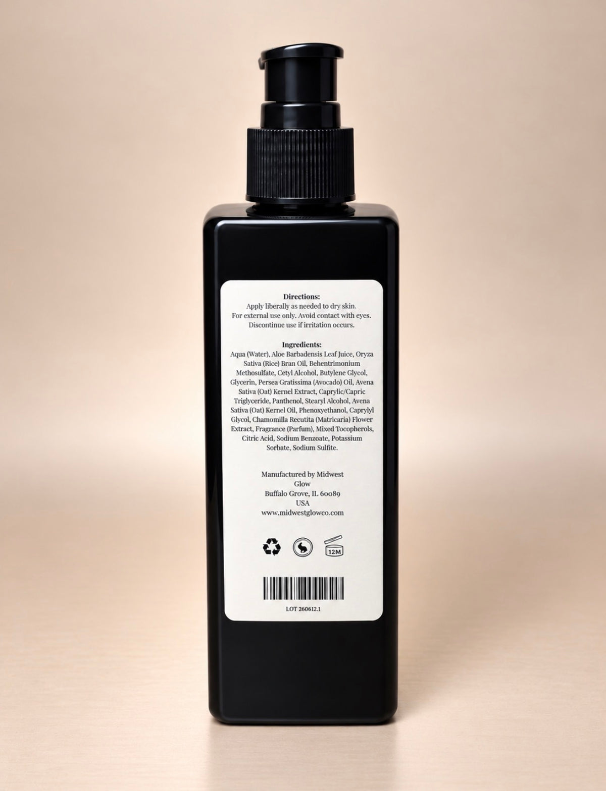 A black pump bottle with a white back label, photographed against a plain beige background. The label contains product information and a barcode, with no brand name clearly visible.