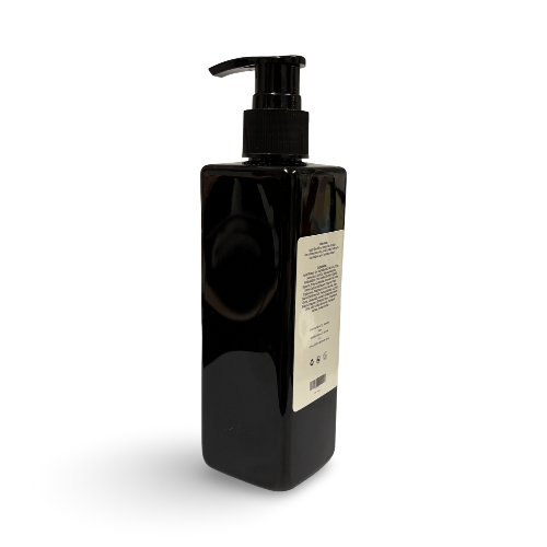 Black bottle with pump and label on a white background