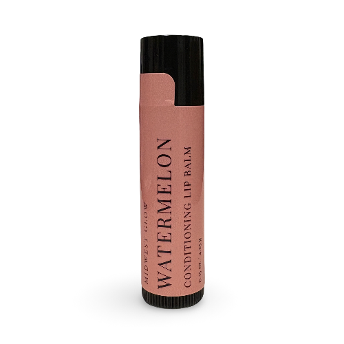 A single tube of lip balm on a plain white background. The tube has a black cap and base, with a dusty pink label that reads 'WATERMELON CONDITIONING LIP BALM' and 'MIDWEST GLOW' vertically on the left side.